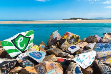 The Vee Wall, a breakwall of painted boulders at Nambucca Heads, Australia clipart