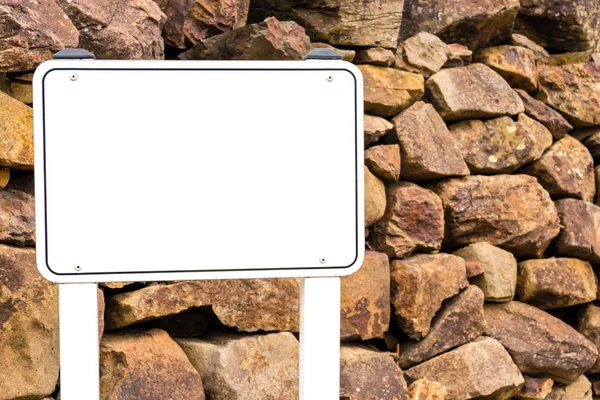 Blank post sign banner against rocky background for creative projects with copy space for text