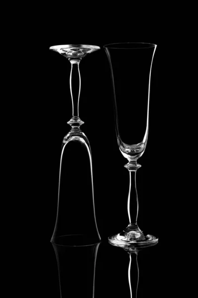 Black and white image empty glass glasses on a black background with a reflection — Stock Photo, Image