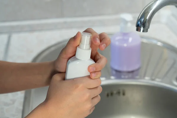 hand hygiene a teenager washes his hands and uses an antiseptic to protect against the virus