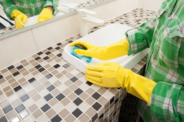 Girl washes a sink in the bathroom