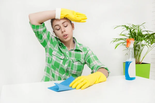 Girl in gloves cleans the apartment