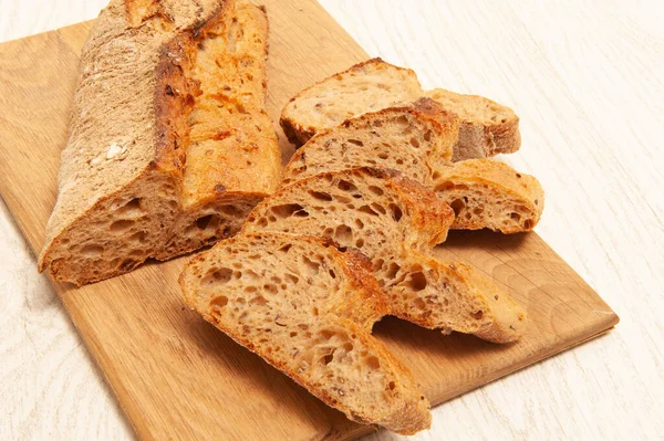 French buckwheat loafs sliced into pieces on a wooden board