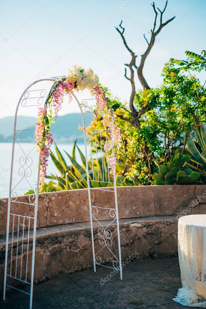 Forged wedding arch. Wedding on the sea at sunset, Montenegro, P