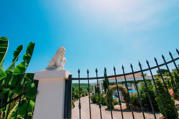 White stone lion statues on the pillars at the gate. Gate holida