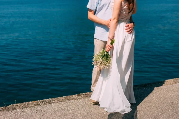 The groom embraces the bride on the beach. Wedding in Montenegro — Stock Photo, Image