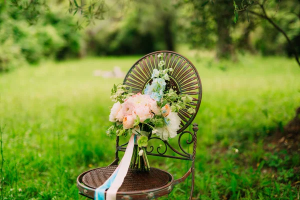 Wedding bouquet of peonies on a vintage metal chair Wedding in M