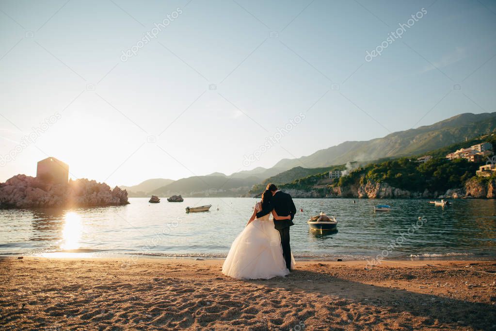 Bride and groom on the beach of the Queen Milocer