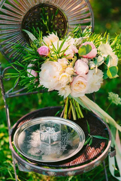 Bruiloft boeket van pioenrozen op een vintage metalen stoel bruiloft in M — Stockfoto