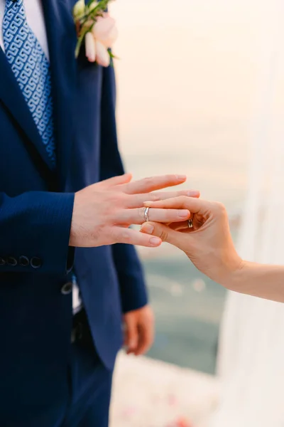 A noiva coloca o anel no noivo no cerimonial de casamento. — Fotografia de Stock