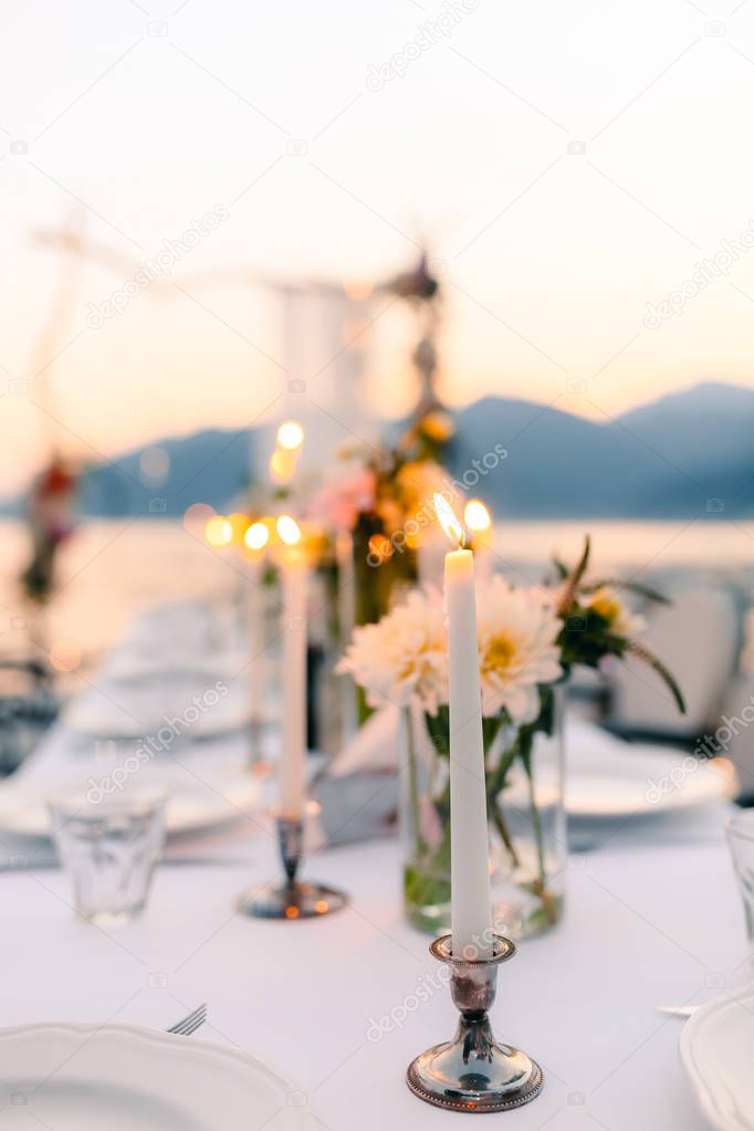 Candles at the wedding banquet. Wedding decorations. Wedding at