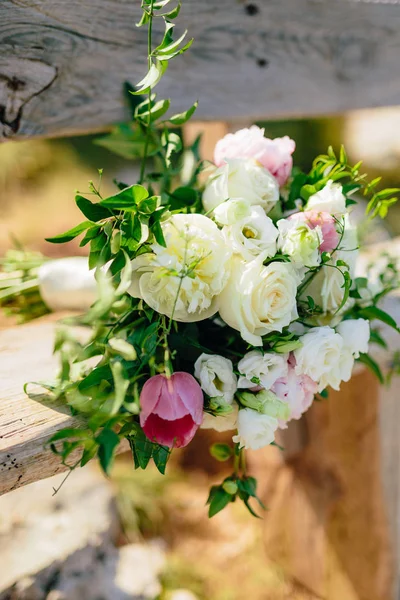 Ramo nupcial de rosas y peonis en un antiguo banco de madera handma — Foto de Stock