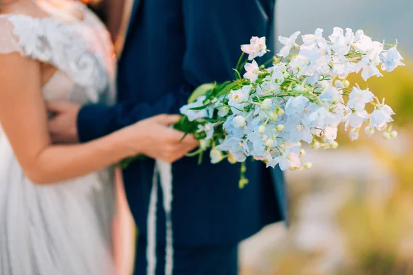 Wedding bridal bouquet of blue Delphinium in the hands of the br — Stock Photo, Image