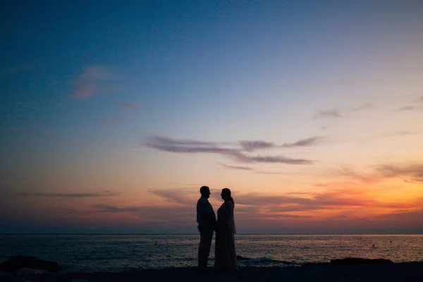 Silhouette al tramonto sulla spiaggia — Foto Stock