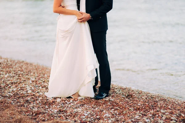 Womens and mens feet in the sand