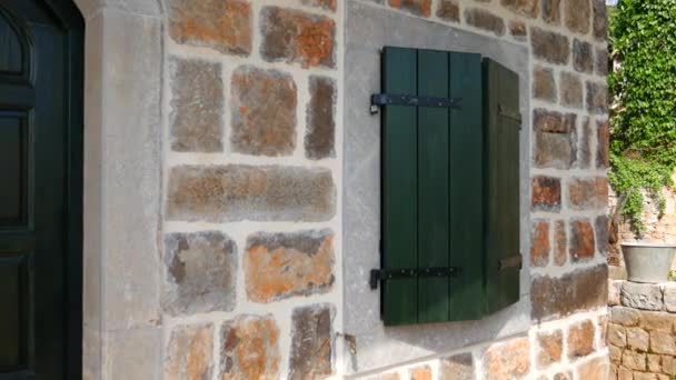 Green window shutters. The facade of houses in Montenegro — Stock Video