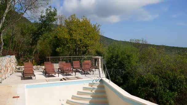 Wooden deck chairs, dark wood in empty swimming pool — Stock Footage Wooden deck chairs, dark wood in empty swimming pool Video Clip