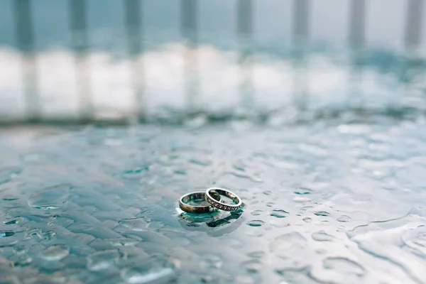 Anéis de casamento na janela à chuva. Gotas no vidro. Tes — Fotografia de Stock