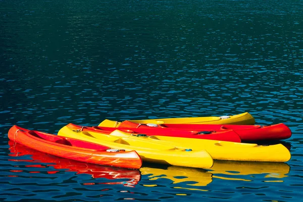 Kayaks moored in the water. Empty kayaks without people. In the