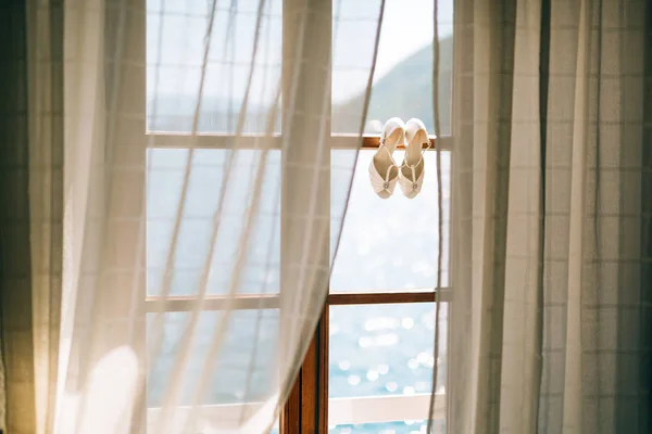 Scarpe nuziali della sposa a una finestra . — Foto Stock