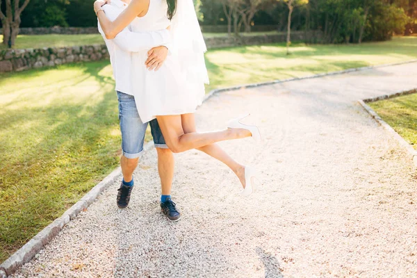 The groom lifted the bride in his arms. Legs close-up. Wedding i