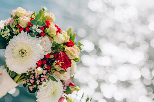 Bridal bouquet of roses and chrysanthemums on a background textu