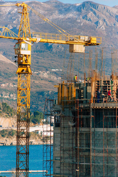 Construction of a multi-storey building. The crane is working. B