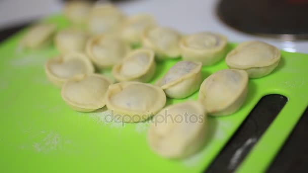 She sculpts dumplings in the kitchen. Cooking food. — Stock Video