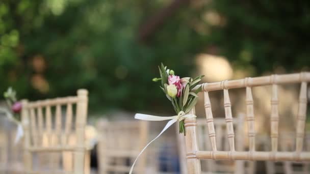 Sillas en una ceremonia de boda. Decorado con arreglos florales — Vídeos de Stock