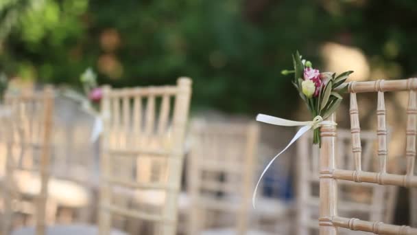 Chairs At A Wedding Ceremony Decorated With Flower Arrangements