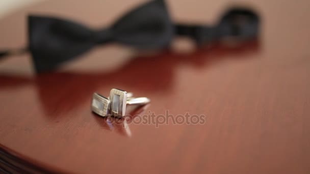 Black shoes of the groom, red bow tie, cufflinks, belt, on a bla — Stock Video