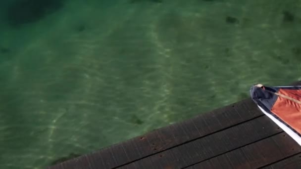 Kayak lies on the shore. Wooden jetty. Bay of Kotor in Montenegr — Stock Video