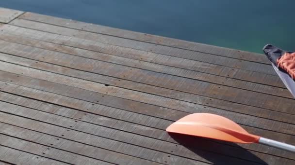 Kayak lies on the shore. Wooden jetty. Bay of Kotor in Montenegr — Stock Video