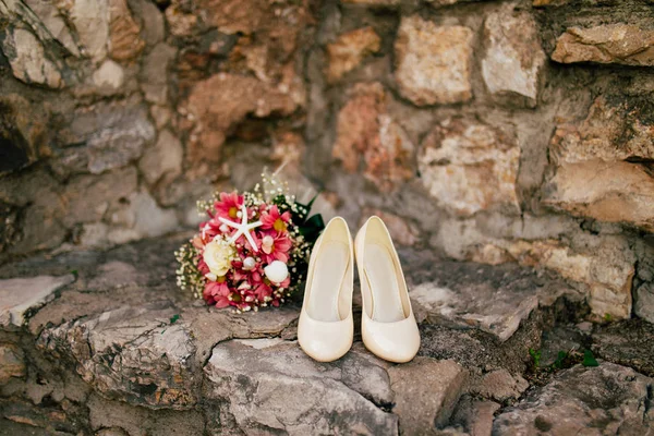 Wedding shoes on the pool background