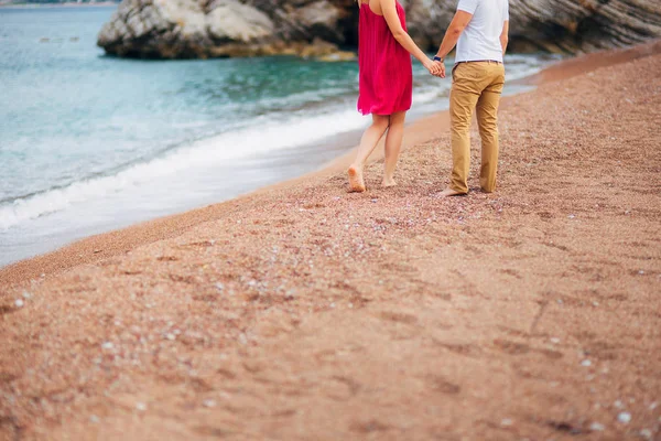 Womens and mens feet in the sand — Stock Photo, Image