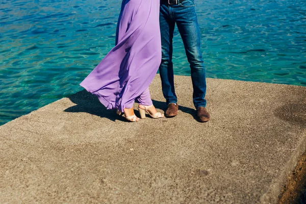 Female and male feet on the dock — Stock Photo, Image