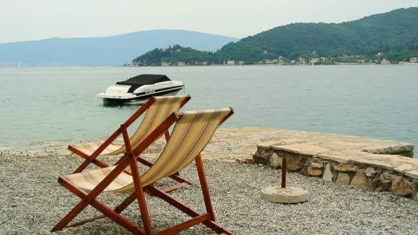 Sun beds and umbrellas on the beach. Montenegrin beaches of the — Stock Video