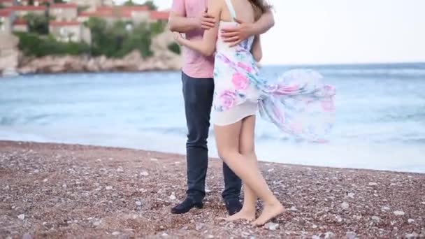 A couple on the beach hugs in Montenegro. Newlyweds are walking — Stock Video