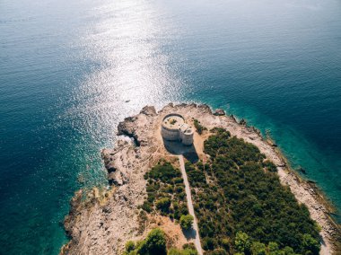 The ancient fort Arza at the entrance to the Bay of Kotor in Montenegro, in the Adriatic Sea, on the peninsula of Lustica. Fortress for military defense. Aerial photo from the drone. clipart