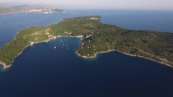 크로아티아 의 콜로 초프 섬 근처에서 드론 비행을 하고 있다. 요트는 바다에 정박 해 있었고,아 드리아 해에 있는 섬의 해안에 자리잡고 있었습니다. 공중에서 맨 위에서 본 광경. — 비디오
