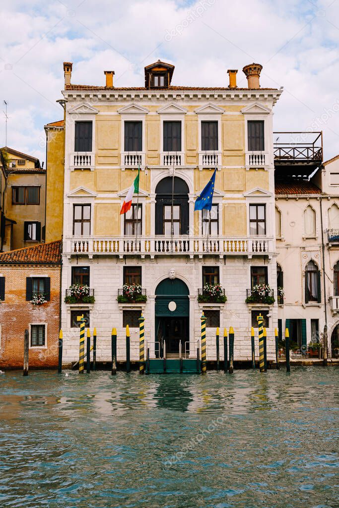 Old houses on Grand Canal, Venice, Italy. Vintage hotels and residential buildings in the Venice center. Historical architecture of Venice on water in summer. Venetian street with ancient facades.