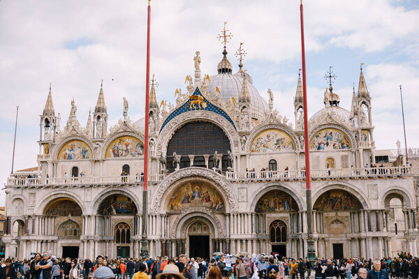 San Marco Cathedral in Venice, Italy, Basilica di Saint Mark. A huge crowd of tourists in the square in front of the cathedral.