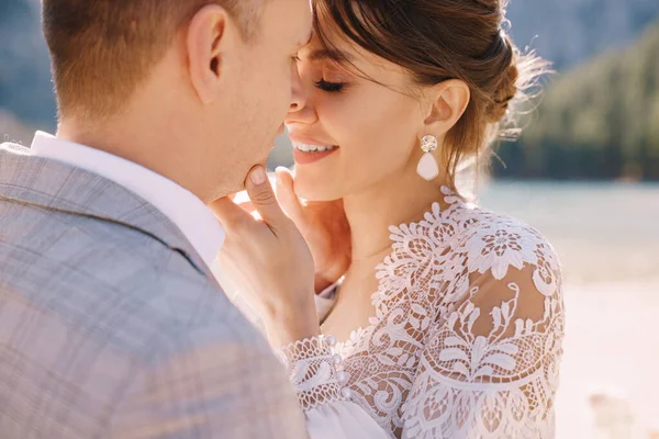 Yeni evliler tören için İtalya 'daki Lago di Braies' in arka planına karşı bir sonbahar sütunları kemeriyle oracıkta öpüşürler. Düğün Avrupa 'da, Braies Gölü' nde.. — Stok fotoğraf