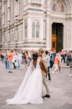 Irklar arası evlilik çifti. Afro-Amerikalı gelin ve beyaz damat Piazza del Duomo 'da kalabalığın arasında öpüşüyor. Düğün Floransa, İtalya 'da