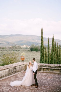 Tuscany, İtalya 'da eski bir şaraphane villasında düğün. Gelin ve damat köşkün çatısında dans ediyorlar..