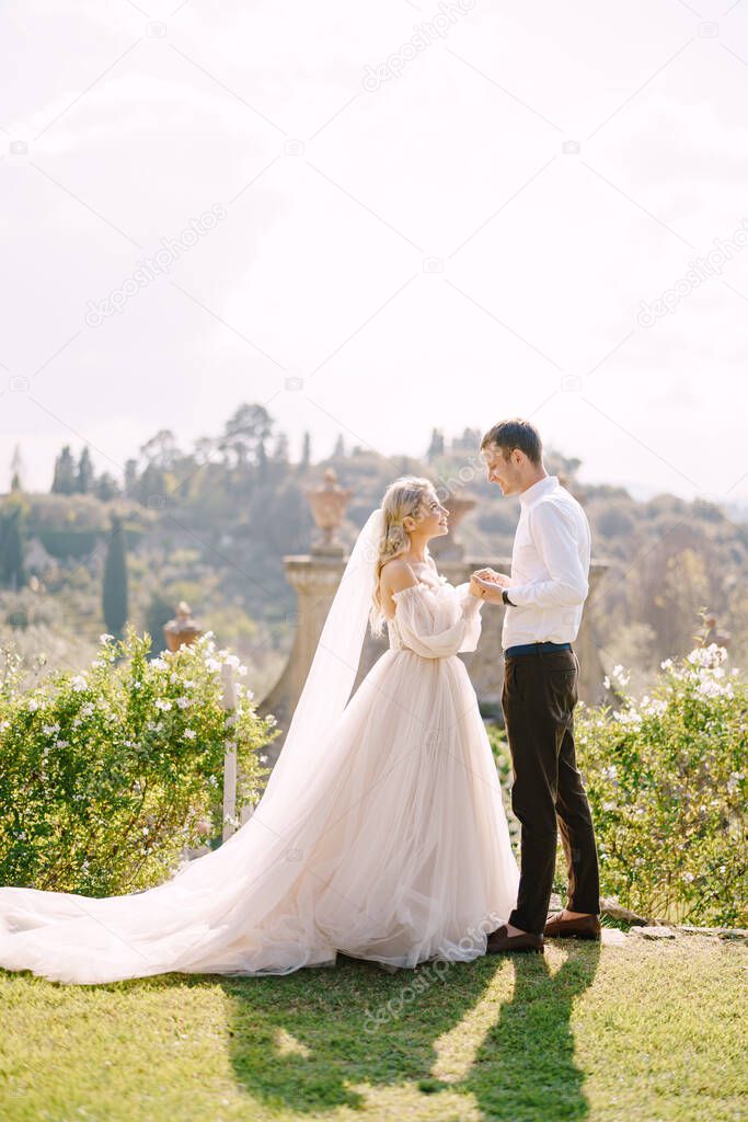 Wedding in Florence, Italy, in an old villa-winery. Wedding couple in the garden at sunset.