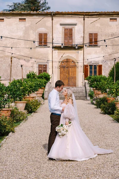 Boda en Florencia, Italia, en una antigua villa-bodega. Pareja de bodas pasea por el jardín. Novia y novio amorosos . —  Fotos de Stock