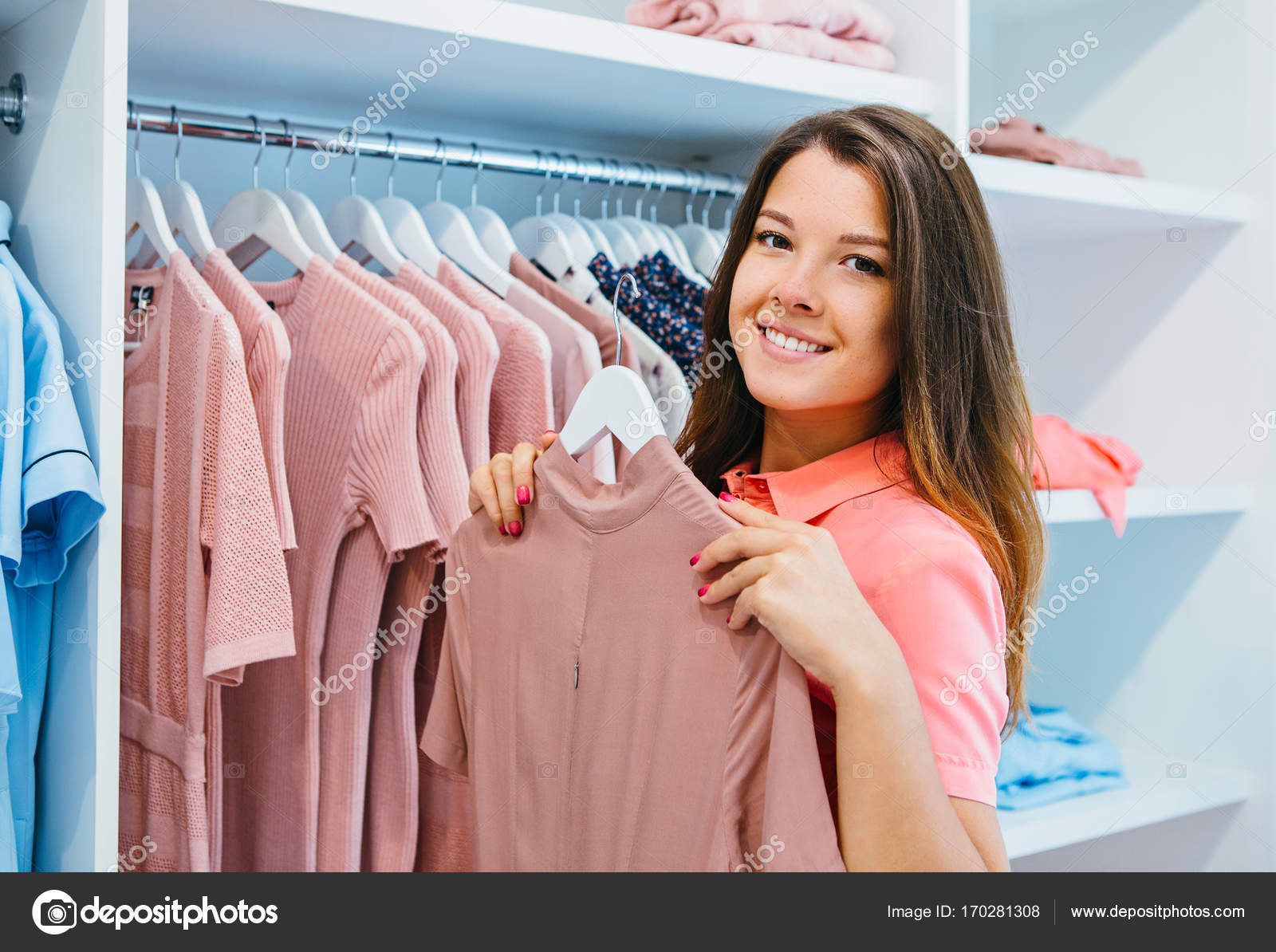 Young woman hanging clothes Stock Photo by Kokulina 170281308