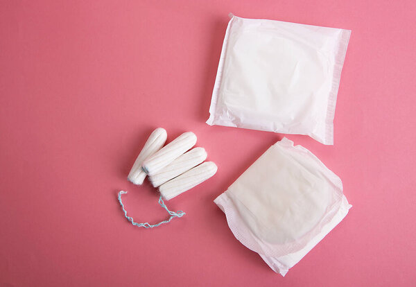 Medical female tampon on a pink background.