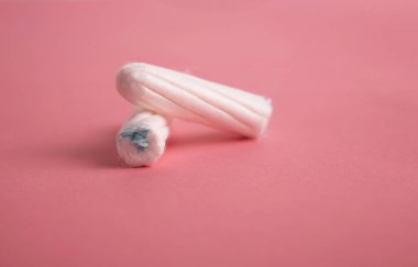 Medical female tampon on a pink background. clipart